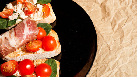 Three bruschetta on a black plate on craft paper