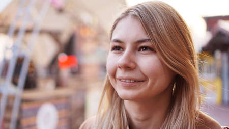 Portrait of a young woman in the city. City food court with street food. Portrait of a smiling blonde. Lifestyle photoの写真素材
