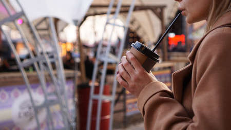 Young blonde with a cup of coffee. Woman at the food court. Lifestyle photo. Beautiful woman drinking coffeeの写真素材