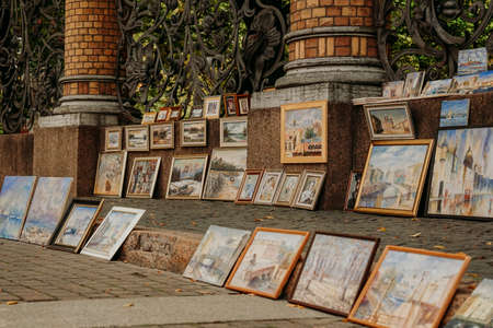 Rows of framed paintings, sale of paintings on the street of the city. Saint Petersburg, September 20, 2021, Russiaのeditorial素材