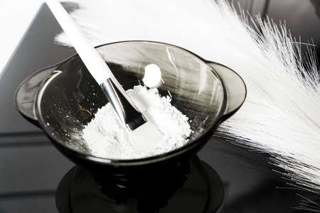 Kaolin clay white powder cosmetic grade for face mask and spa treatments. Black and white colorsの写真素材