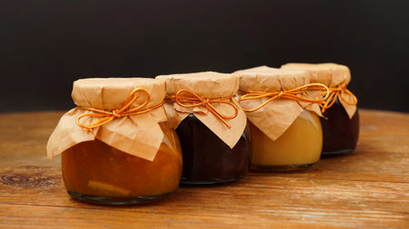 Home-made jam, selective focus. Jars with marmalade, confiture. Sweet dessert for toast, pie....