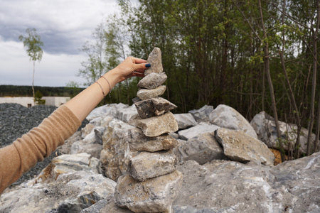 Pyramid made of stones. Piles of pyramids of stones in a former marble quarry, Karelia. The hand...