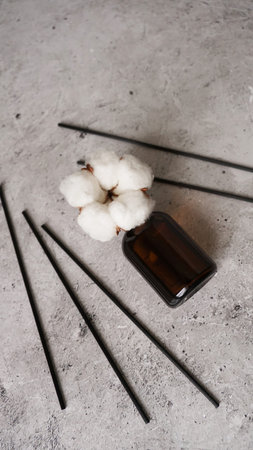 Transparent bottle of aroma diffuser. Parfum for home with cotton flowers. Trending concept, natural...