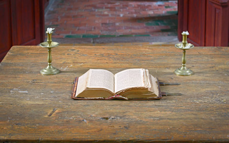 Very old open bible on table in medieval churchの写真素材