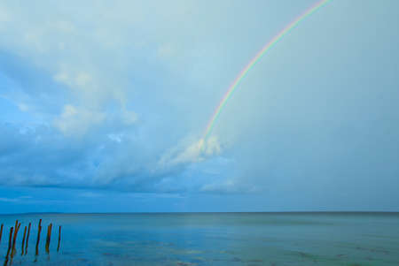 Beautiful, bright and real rainbow across the oceanの写真素材