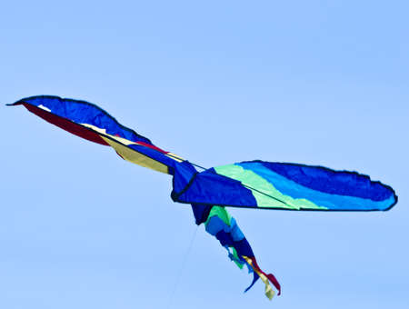 A beautiful, colorful stunt kite, in the blue sky, high up in the windの写真素材