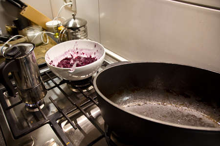 A very dirty kitchen after cooking a meal for a celebrity, with used dishes, ready for tidy upの写真素材