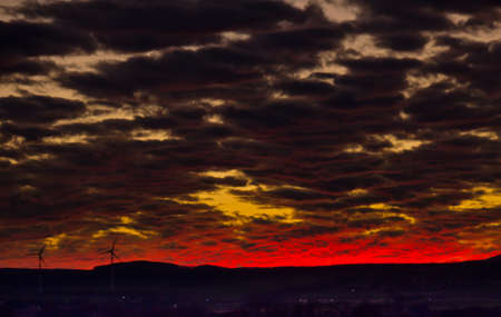 A very extraordinary and beautiful sunset in orange and purple colors, lightened and brightの写真素材