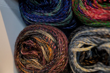 colorful woolen threads for knitting as a background close-up