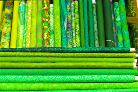 Rolls of green and yellow fabric for sale at a market stall, green and yellowの写真素材