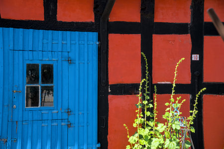 traditional small, red, Danish framehouse in summer in Bornholm with blue sky