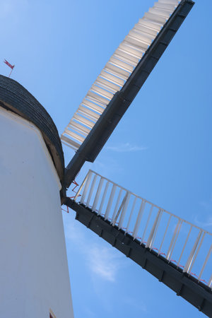a beautiful ancient white windmill in Aarsdale, Bornholm on a sunny day with blue sky
