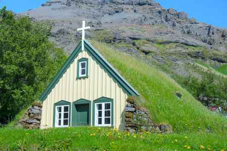 Small wooden church with thatched roof and green grass, Icelandの写真素材