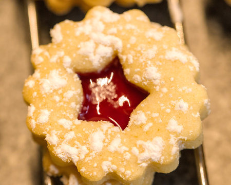 Close up of homemade cookies with strawberry jam. Selective focus. Christmas