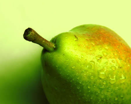 Green pear on a gradient background closeupの写真素材