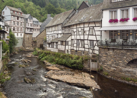 Half-timbered houses on the banks of the Rur in Monschau. Editorial-All year round-Monschau-Germany; All year round, Monschau attracts many tourists from all over the world.のeditorial素材