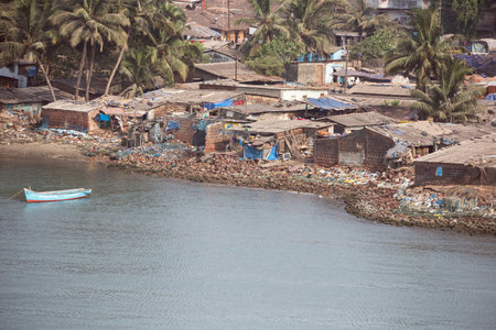 Editorial: MORMUGAO, GOA, INDIA, April 11, 2017 - Ramshackle houses on the bank of the Zuari River in Mormugaoのeditorial素材