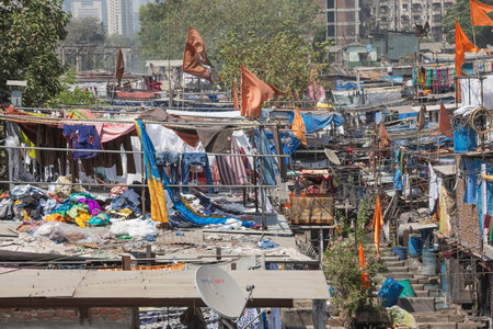 Editorial: MUMBAI, MAHARASHTRA, INDIA, April 12, 2017 - Laundry piled up on roofs in the Mahalaxmi Dhobi Ghat open air laundromat in Mumbaiのeditorial素材
