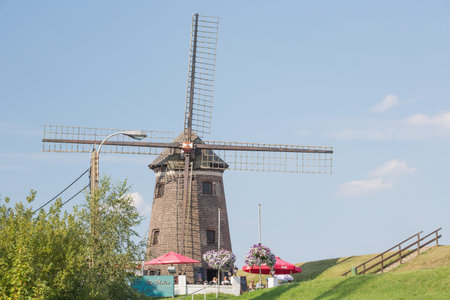 Editorial: DOEL, BELGIUM, August 27, 2017 - The windmill on the bank of the Scheldt in Doel. On...