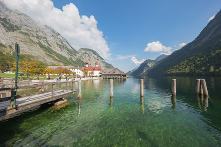 Editorial: BERCHTESGADEN, GERMANY, September 25, 2017 - The Koningssee with St. Bartholomew's Church and the surrounding mountain rangeのeditorial素材