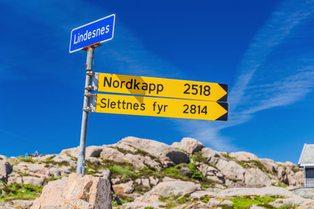 Signpost near the Lindesnes lighthouse indicating the distance to the North Cape and the...