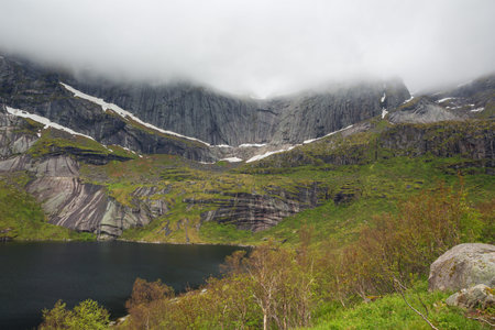 Low cloud over the mountains near Nusfjord. Although it is mid june at sea level there are still...