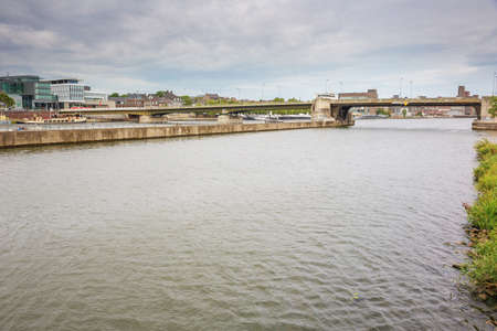 The Wilhelmina bridge spanning over the river Meuse with the Maastricht skylineの写真素材
