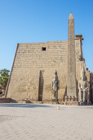 The right hand side of the Temple of Luxor with an obelisk and statues of Ramesses IIの写真素材
