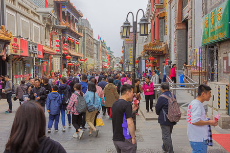 Editorial: BEIJING, CHINA, April 6, 2019 - Looking over the heads of the crowd in Dashilan St, a hutong in Beijingのeditorial素材