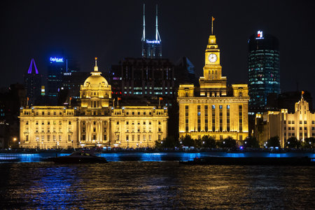 Editorial: SHANGHAI, CHINA, April 16, 2019 - Looking over the Huangpu River at the Bund at night in Shanghaiのeditorial素材