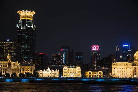 Editorial: SHANGHAI, CHINA, April 16, 2019 - The Bund Center and surrounding buildings at night in...