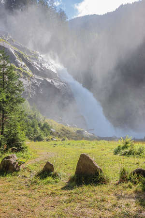 Krimmler Waterfalls in golden afternoon sun, seen from its baseの写真素材