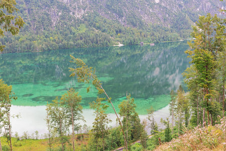 Turquoise water and reflections in the Almsee, on the hike to the Ameisstein