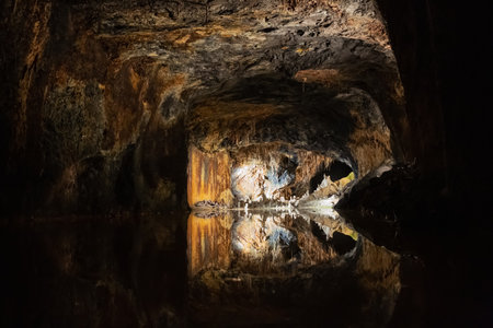 Strangely formed speleothems at the end of a dark gallery in the colorful Fairy Grottoes in Saalfeldの写真素材