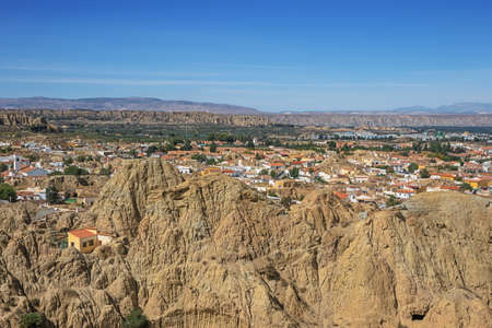 Tuff hill with Guadix in the background, seen from the Caves lookoutの写真素材