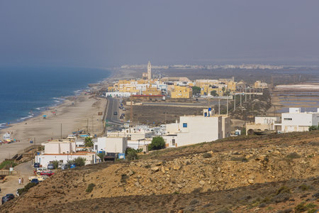Editorial: CABO DE GATA, ANDALUSIA, SPAIN, SEPTEMBER 25, 2021 - View of the Cabo de Gata coastline with la Almadraba village. Due to the intense heat , the view is blurred and distorted.のeditorial素材