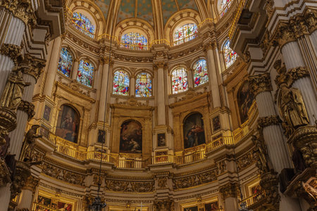 The wall under the cupola of the Granada Cathedral, which is richely decorated with paintings. Names...