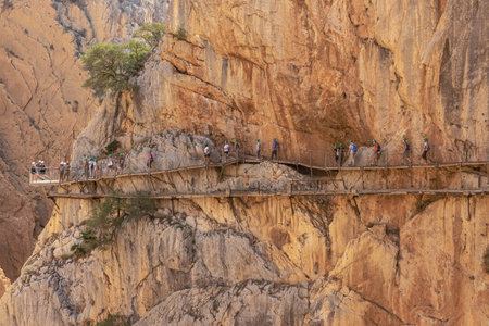 Editorial: CAMINITO DEL REY, ARDALES, ANDALUSIA, SPAIN, OCTOBER 1ST, 2021 - Tourists walking over the King's pathway in the gorge of the Guadalhorce river in the vicinity of Ardalesのeditorial素材