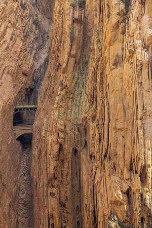 The railway through the Guadalhorce gorge peeping between two tunnels between two vertically folded rock formations, seen from the King's pathwayの写真素材