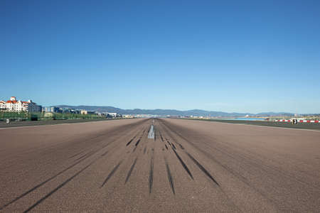 In the middle of the runway at Gibraltar airport. Distant objects are blurred due to the heat coming from the concreteの写真素材