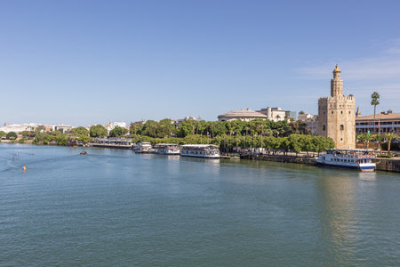 Editorial: SEVILLE, ANDALUSIA, SPAIN, OCTOBER 10, 2021 - An arm of the Guadalquivir, running through Seville's city center with with the Golden Tower on the right bankのeditorial素材
