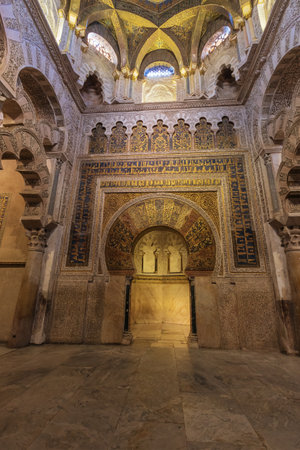 The mihrab and part of the dome in Cordoba's cathedral. A mihrab is used in a mosque to identify the wall that faces Mecca, the birth place of Islam in what is now Saudi Arabia.のeditorial素材