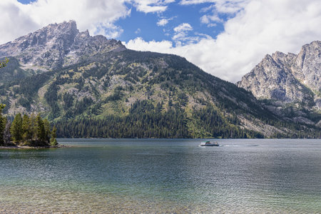 Jenny Lake and the Teton Range with a shuttle on the lake in the Grand Teton National Parkの写真素材