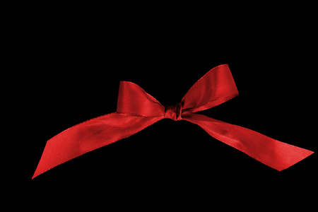 Red ribbon bow on black backgroundの写真素材