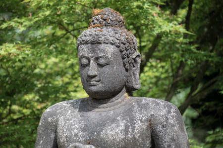 Rock Buddha statue with sunlight used for amulets of Buddhism religion. Buddhism is popular region in China Japan and south east Asia.の写真素材
