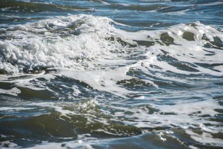 Sea wave foam on the beach in Estepona, Andalucia, Spain. Peaceful ocean waves at beach.の写真素材