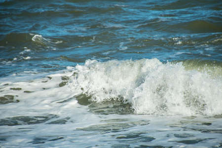 Sea wave foam on the beach in Estepona, Andalucia, Spain. Peaceful ocean waves at beach.の写真素材