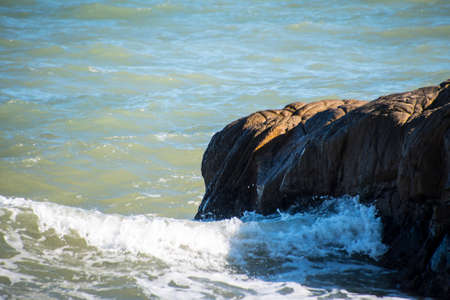 Sea wave foam and rocks on the beach in Estepona, Andalucia, Spain. Peaceful ocean waves at beach.の写真素材