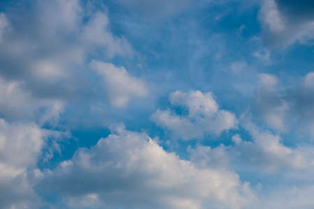 White clouds on the blue sky. Abstract background with clouds on blue sky. In the clear sky high floating clouds.の写真素材